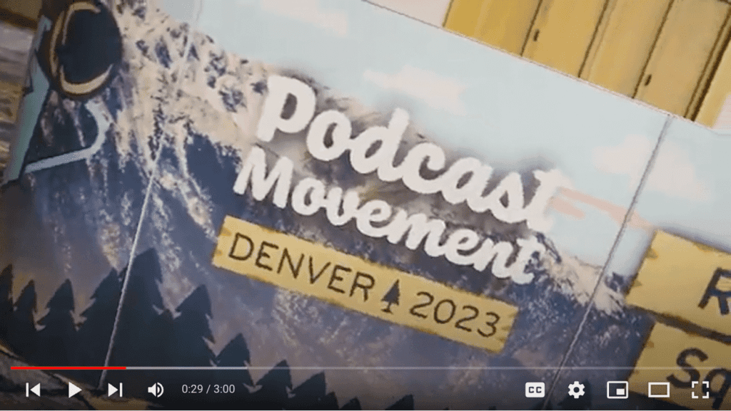 This is a screen grab image from the PM23 recap video on YouTube. Screen grab includes a piece of signage that says "Podcast Movement Denver 2023"